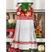 The completed hanging towel in red, hung from a kitchen drawer and staged with coordinating decor like a candle, cooking utensils, and a gingerbread man.