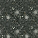 A black patterned fabric featuring white spiderwebs and various flowers and leaves.
