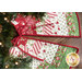 A top down shot of the backside of the tree skirt underneath a decorated Christmas tree on a dark wood grain floor.