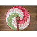 A top down shot of the tree skirt, demonstrating the full effect of the Bargello design, isolated on a dark wood grain background.