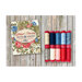 Cover of Grand Haven with floral design beside spools of thread in red, blue, and cream on wood background.