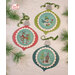 The completed projects, staged on a wooden background and surrounded by coordinating holiday greenery.
