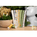 A stack of Safari themed fabrics that are included in the Sunny Safari collection, with an elephant and a lion and greenery and thread.