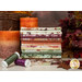 A stack of the fabrics included in the Rustle FQ set, with leaves and candles and a basket and thread.
