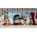 Holiday decorative pillow featuring a snowman, cardinals, and a small house in a snowy scene.