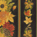 Scanned swatch of the black border stripe fabric interspersed with rows of fall leaves, florals, and pinecones with metallic accents.