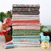 A stack of 39 fabric fat quarters in floral and geometric patterns, featuring pastel colors.