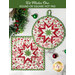 Two quilted hot pads, one round and one square, featuring a star design in red, white, and green Christmas fabrics displayed on a white marble counter with coordinating seasonal decor. A green banner at the top reads 