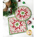 A top-down shot of the two round and square quilted hot pads slightly overlapping on a white marble counter while coordinating Christmas table decor is scattered across the counter around the hot pads.