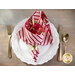 A top down shot of a place setting with the candy cane striped fabric of the napkin faced out.