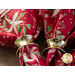 A close up of the napkins slightly fanned out on a wood table top, held by brushed gold napkin rings.