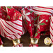 A close up of the napkins slightly fanned out on a wood table top, held by brushed gold napkin rings.