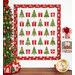 The completed Christmas Wishes quilt colored in red, white, and green fabrics from the Once Upon a Christmas collection, hung on a white paneled wall and bordered by a decorated Christmas tree and coordinating seasonal decor.