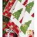 A close up on the draped Christmas Wishes quilt, demonstrating fabric, topquilting, binding, border, and form details.