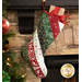 A festive Christmas stocking hanging from a stone fireplace, decorated in fabrics from the Woodland Winter collection