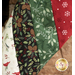 A close-up of Christmas Stocking made with festive fabrics featuring pinecones, berries, leaves, and snowflakes in various colors.