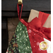 A Christmas stocking hanging from a hook, featuring festive patterns in red, green, and white.