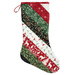 A Quilted Christmas stocking in red, green, and white, featuring festive fabrics from the Woodland Winter collection isolated on a white background