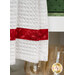 A close-up of the bottom of the white textured hanging towel with a stripe of red fabric.