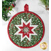 Circular quilted hot pad featuring a star design in red, white, and green fabrics with a festive pine pattern.