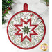 Round quilted table runner featuring a star design in red, green, and white fabrics, with a hanging loop.