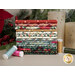 A stack of fabrics featured in the All is Bright collection, with candles and pine branches and berries and thread.