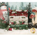A stack of the fabrics included in the Woodland Snowmen set, with trees and snow and mushrooms and pinecones and a snowman and thread.