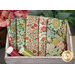 A stack of the Green Wallflower 5 FQ set with thread and a wooden box and flowers
