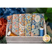 A stack of the Blue Wallflower 5 FQ set with thread and a wooden box and flowers.