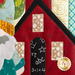 A super close up on the applique schoolhouse, demonstrating fabric and topstitching details.