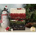 A stack of 20 fat quarters of festive flannel fabric, with a tree and berries and a snowman and thread.