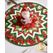 An adorable smiling Santa decoration sits at the center of the topper, staged with matching table settings.