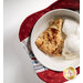 A top down shot of the bowl cozy colored in patriotic colors, with a bowl of dessert in the center, demonstrating usage, fabric, and stitching details.