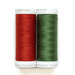 Two spools of thread in red and green isolated on a white background.