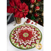 The completed Point of View Kaleidoscope Folded Star Table Topper colored in Holly Berry Park, displayed on a white table with coordinating flowers and Christmas decor.