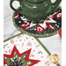 An angled shot of the round and square hot pads in black and white, staged on a white marble countertop with a green teapot.