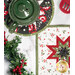 A top-down shot of the round and square hot pads in black and white, staged on a white marble countertop with coordinating decor like garlands, baking utensils, and a green teapot.