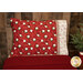 The completed Our Gnome to Yours - Standard Size Pillowcase in red, staged on a red bed against a rustic wood wall.