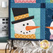 A close up on the lower left snowman, demonstrating fabric, piecing, laser shape, and top stitching details.