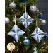 The three completed Cathedral Window Ornaments colored in blue and white fabrics from the Holiday Flourish Festive Finery collection, staged on a decorated Christmas tree.