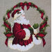 The completed The Spirit of Christmas cross stitch hung in an ornate wooden frame.