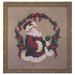 The completed The Spirit of Christmas cross stitch hung in an ornate wooden frame.