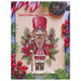 Front of pattern showing a digitized version of the finished project, featuring a nutcracker surrounded with hollies and a poinsettia