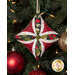 A head on shot of one of the ornaments, colored in scarlet, white, and olive fabrics, staged on a Christmas tree.