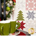 A stylized shot of the quilt, focusing on a handful of patchwork blocks while a Christmas tree and two green mugs of hot cocoa peek into frame from the left side.