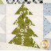 A super close up on a green patchwork Christmas tree, showing print and top quilting details.