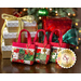 Three tiny tote bags with red straps, patchwork, and decorative golden charms, displayed on a table and staged with Christmas presents.