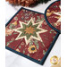 Patchwork quilted hot pad featuring a star pattern in earthy tones, with floral designs.