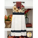 Decorative kitchen towel with a floral top and textured white bottom, hanging from a drawer handle