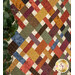 A colorful patchwork quilt featuring various fabrics in warm tones.